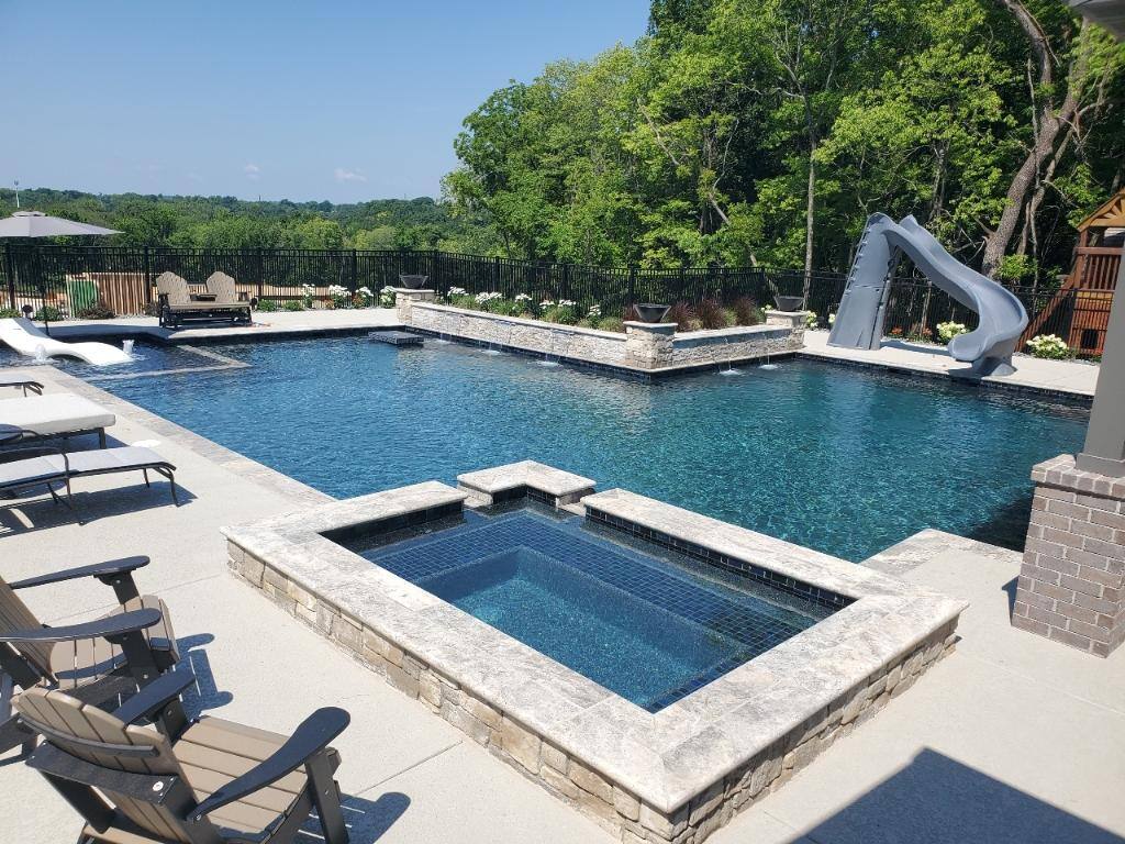 geometric, gunite pool with raised spa, tanning ledge, bubblers, and slide